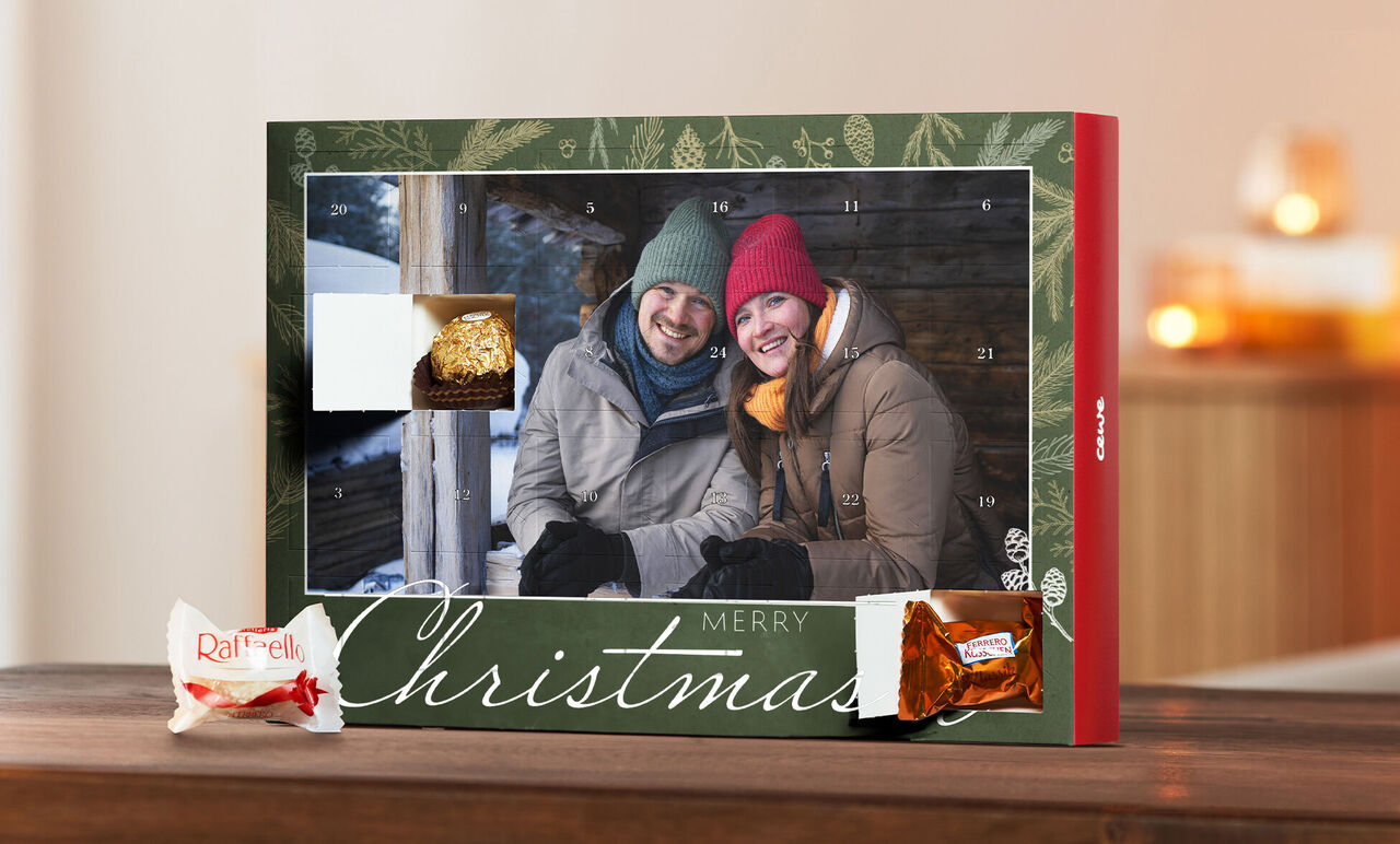 Two people excitedly look at an Advent calendar with festive snacks.