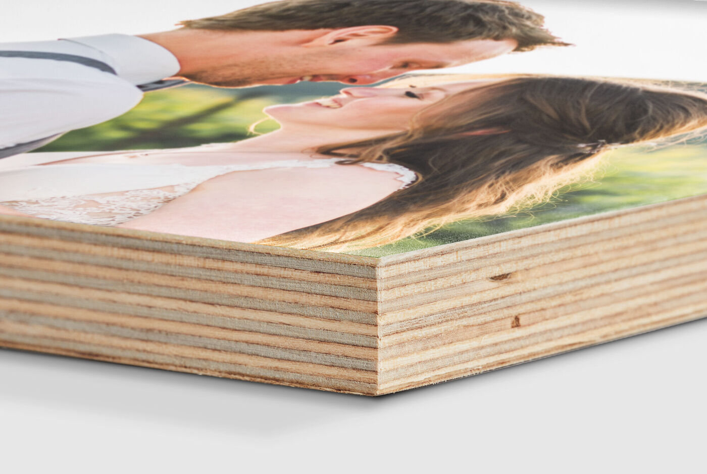 Close-up of a CEWE photo book with a happy couple on the cover smiling at each other.
